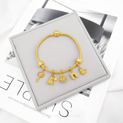 Gold Pandora Charm Bracelet by Chip Lee Jewellery Singapore, symbolising Parisian elegance, perfect for meaningful gifts or personal keepsakes.