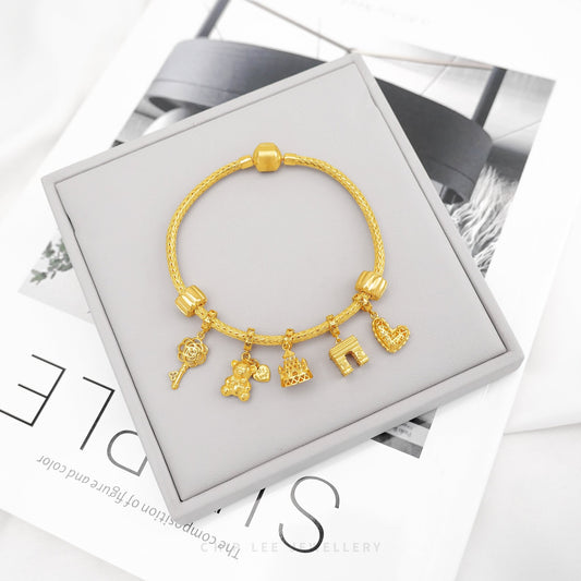 Gold Pandora Charm Bracelet by Chip Lee Jewellery Singapore, symbolising Parisian elegance, perfect for meaningful gifts or personal keepsakes.