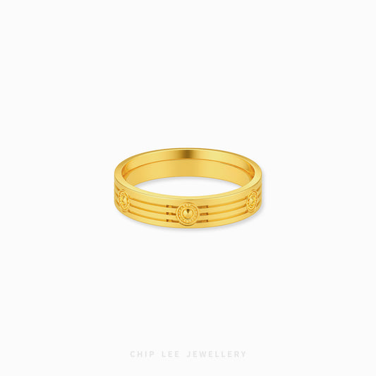 A gold band ring with a textured, ridged outer surface and circular medallion details, shown on a clean white background with 'CHIP LEE JEWELLERY' text at the bottom.