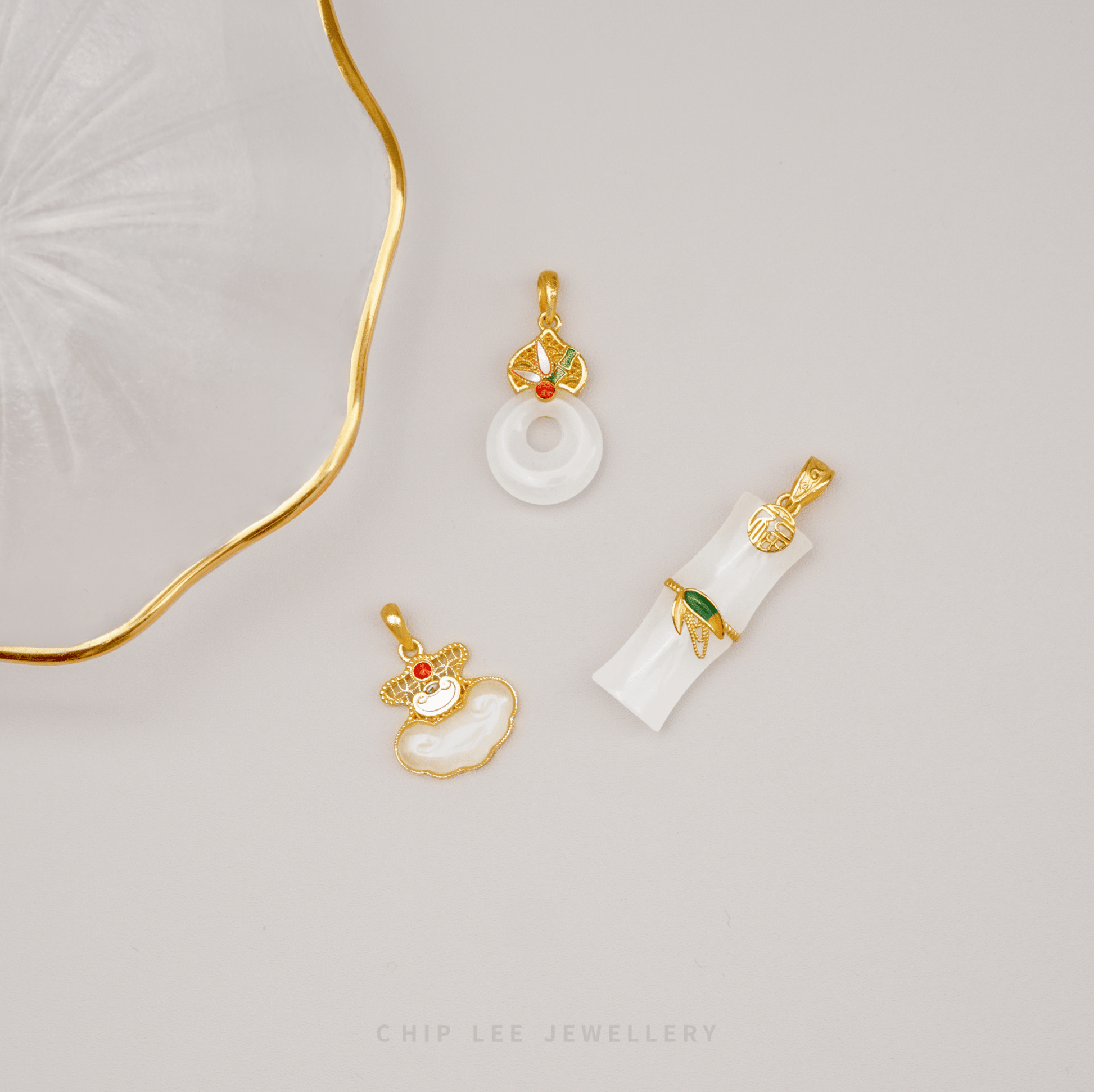 Three gold and white pendants on a light gray background with 'CHIP LEE JEWELLERY' branding.