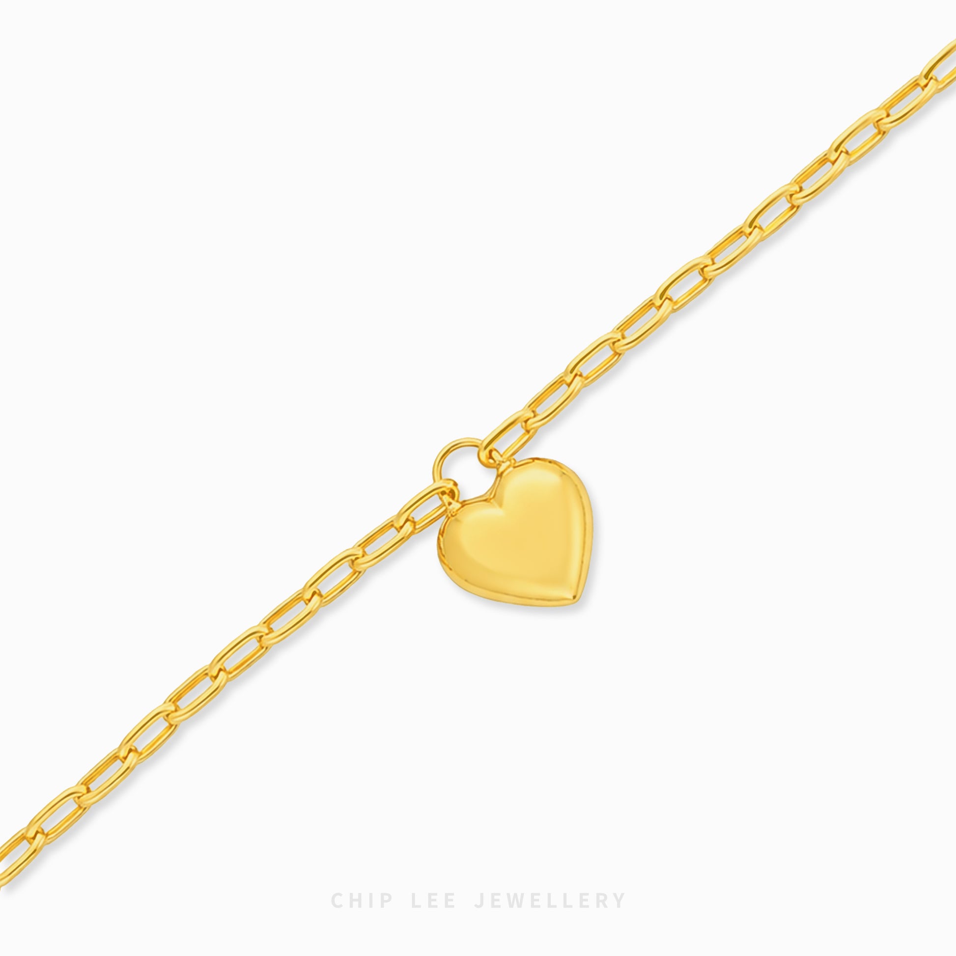 A gold paperclip chain bracelet with a flat, polished heart charm, displayed on a clean white background with the brand name 'CHIP LEE JEWELLERY' printed at the bottom.