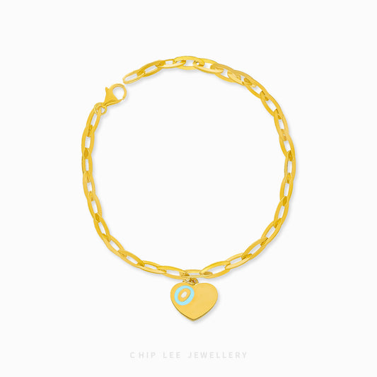 Dainty heart charm bracelet adorned with turquoise enamel detail, certified and hallmarked by Singapore Assay Office for purity and authenticity.