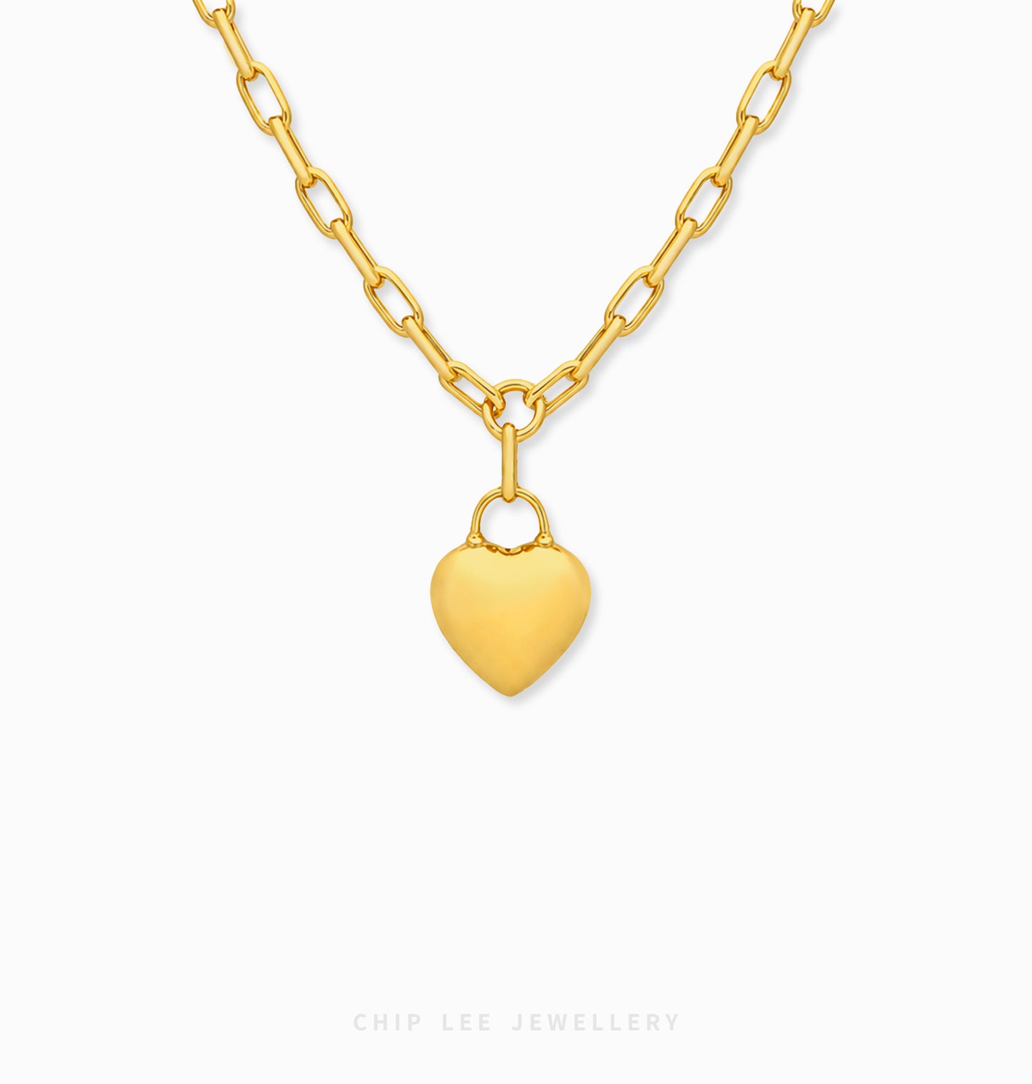 A gold heart pendant necklace with a matching gold chain, shown against a plain white background with a Chip Lee Jewellery brand watermark at the bottom.