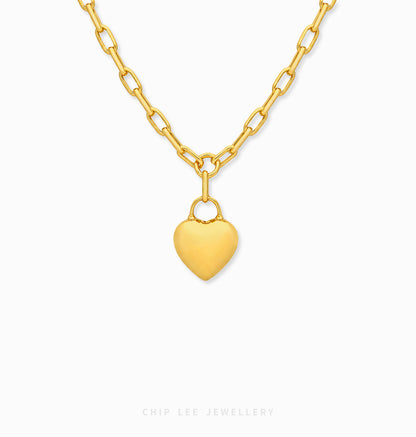 A gold heart pendant necklace with a matching gold chain, shown against a plain white background with a Chip Lee Jewellery brand watermark at the bottom.