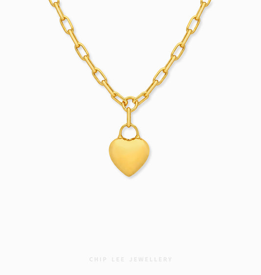A gold heart pendant necklace with a matching gold chain, shown against a plain white background with a Chip Lee Jewellery brand watermark at the bottom.