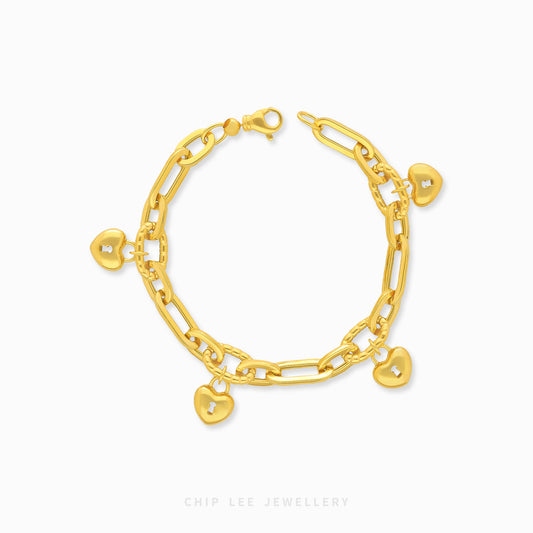 Gold bracelet with heart charms on a white background, branded 'Chip Lee Jewellery'.