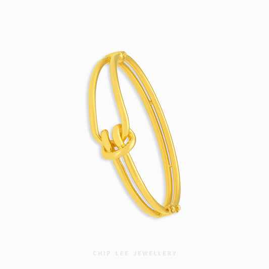 Knot Bangle Bracelet featuring an elegant knot centerpiece and sleek bangle design