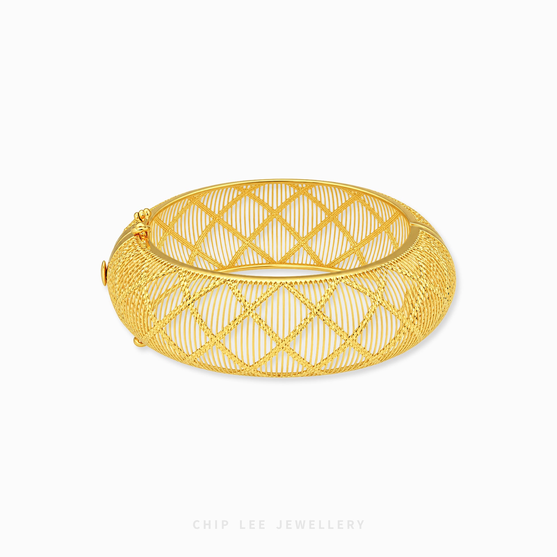 A gold bangle bracelet with a geometric openwork wire design, displayed on a clean white background with a brand watermark at the bottom.