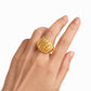 Gold ring on a hand with a white background