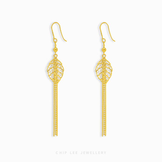 Gold filigree tassel earrings on a white background