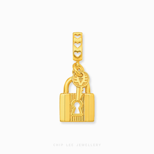 A gold padlock and key charm with a matching rectangular link featuring three heart cutouts, shown on a light gray background with the brand name 'CHIP LEE JEWELLERY' at the bottom.