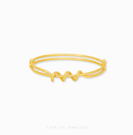 Looped Knot Bangle with bold sculptural knot design, modern statement style, elegant women’s jewelry bracelet