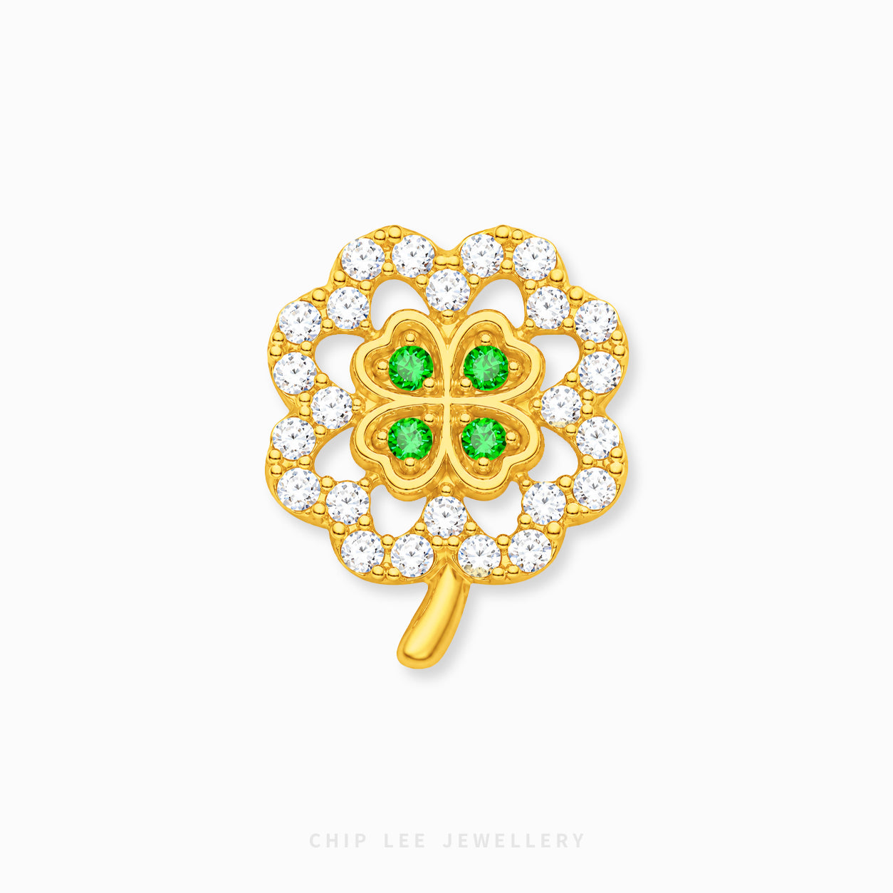 A gold four-leaf clover charm with four green gemstones in the center and a border of clear cubic zirconia stones, shown on a light gray background with a Chip Lee Jewellery watermark.