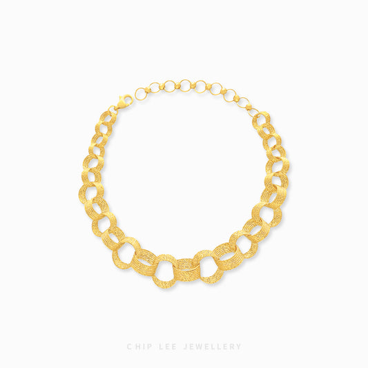 A gold bracelet with a chain link design.