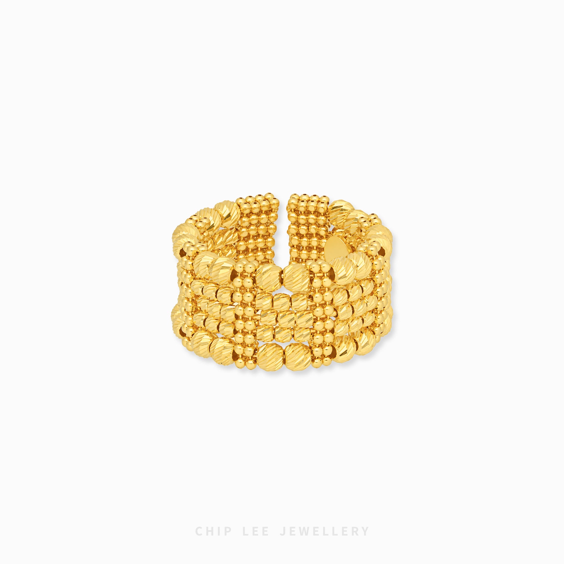 A wide, multi-strand gold ring with textured beaded and ribbed bands, displayed on a clean white background with a subtle shadow.