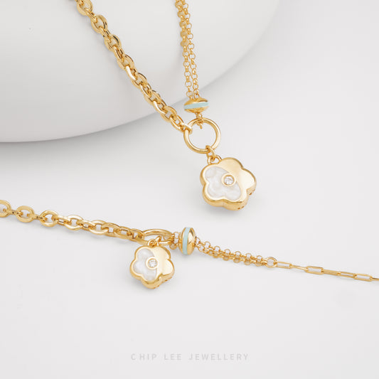 Mother-of-Pearl Enamel Flower Necklace and Bracelet set in solid 916 gold with exquisite floral design, hallmarked in Singapore for certified purity and 
authenticity.