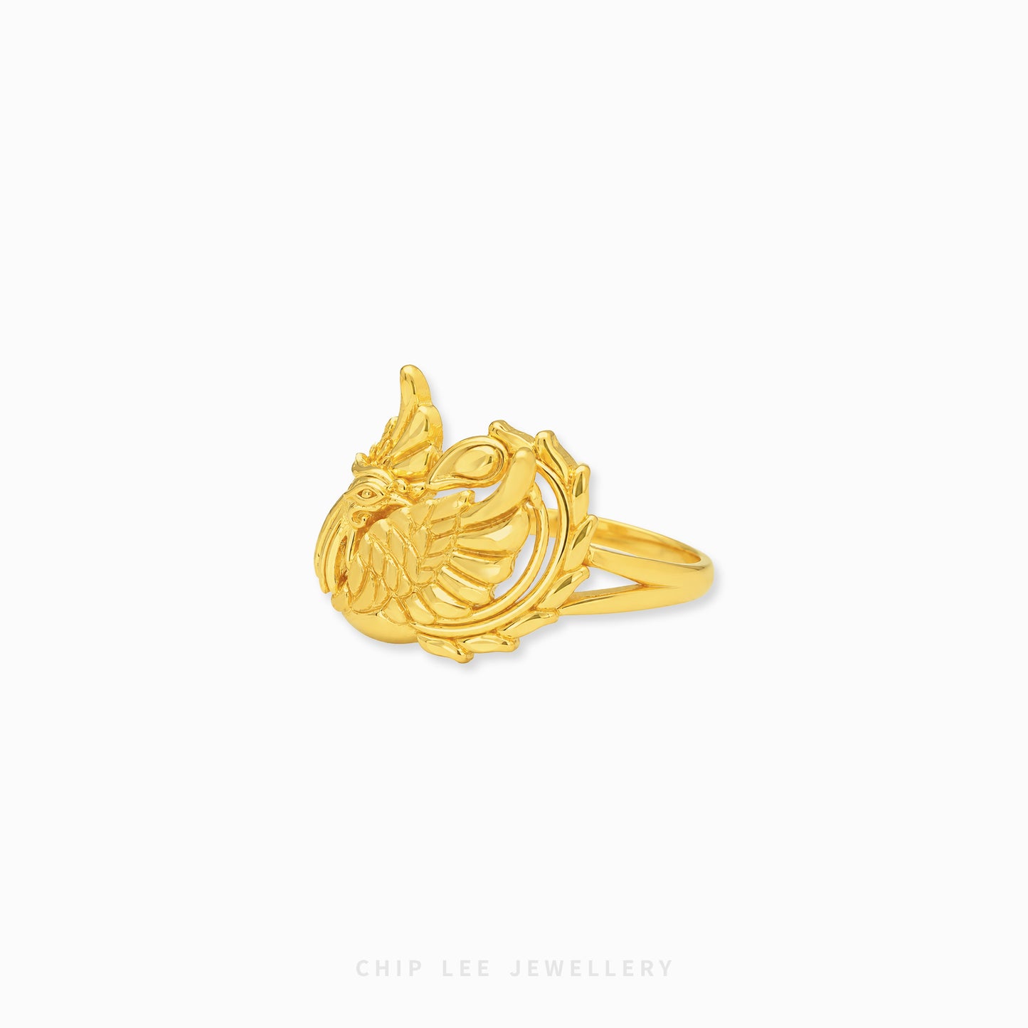 Gold phoenix-inspired statement ring featuring intricate feather detailing and an openwork mythical bird design with a polished luxurious finish.