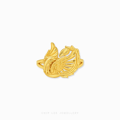 Gold phoenix-inspired statement ring featuring intricate feather detailing and an openwork mythical bird design with a polished luxurious finish.