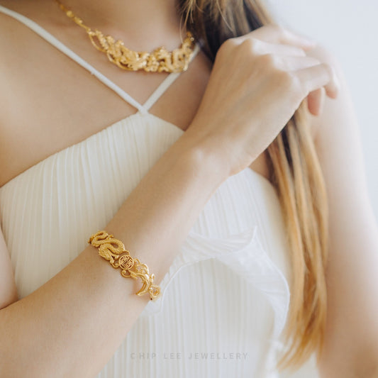 Phoenix and Dragon "龙凤" Joyous Unity Bangle by Chip Lee Jewellery Singapore, 916/22K gold, intricate design symbolizing harmonious union and prosperity.
