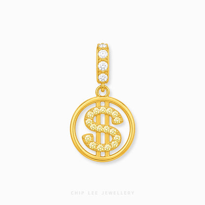 A gold pendant featuring a circular openwork design with a dollar sign motif, embellished with small clear stones, and a top bail with four clear stones, shown on a light gray background.