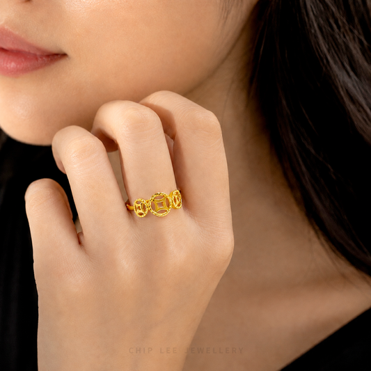 A gold ring featuring three interlocking Chinese copper money symbols, shown on a clean white background with the brand name 'CHIP LEE JEWELLERY' printed at the bottom.