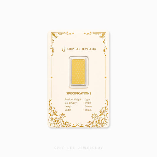 A gold bar jewelry piece in a clear plastic capsule, mounted on a cream-colored display card with gold decorative borders and specifications printed on it. The brand name 'CHIP LEE JEWELLERY' is visible on the card.