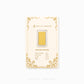 A gold bar jewelry piece in a clear plastic capsule, mounted on a cream-colored display card with gold decorative borders and specifications printed on it. The brand name 'CHIP LEE JEWELLERY' is visible on the card.