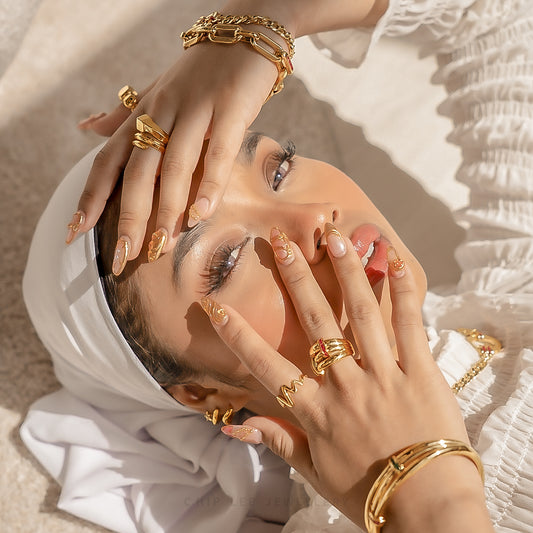 Bold 916 gold bangle featuring ruby and emerald tone cubic zirconia design. Hallmarked by Singapore Assay Office for certified purity and authenticity.