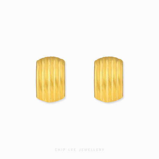 Ribbed hoop earrings with textured ridged detailing and polished gold finish.
