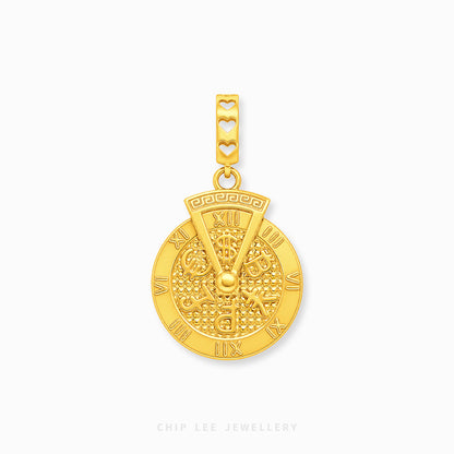A gold charm featuring a circular wheel design with Roman numerals and a bail decorated with three heart cutouts, shown on a light gray background.