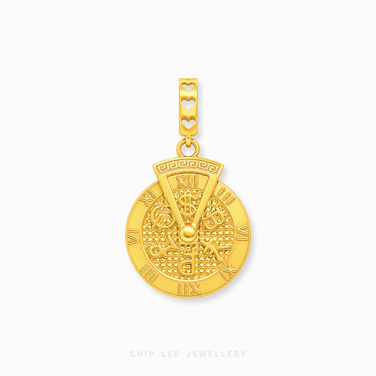 A gold charm featuring a circular wheel design with Roman numerals and a bail decorated with three heart cutouts, shown on a light gray background.