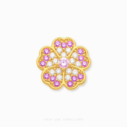 A gold flower-shaped charm embellished with pink and clear gemstones, centered on a light gray background with 'CHIP LEE JEWELLERY' text at the bottom.