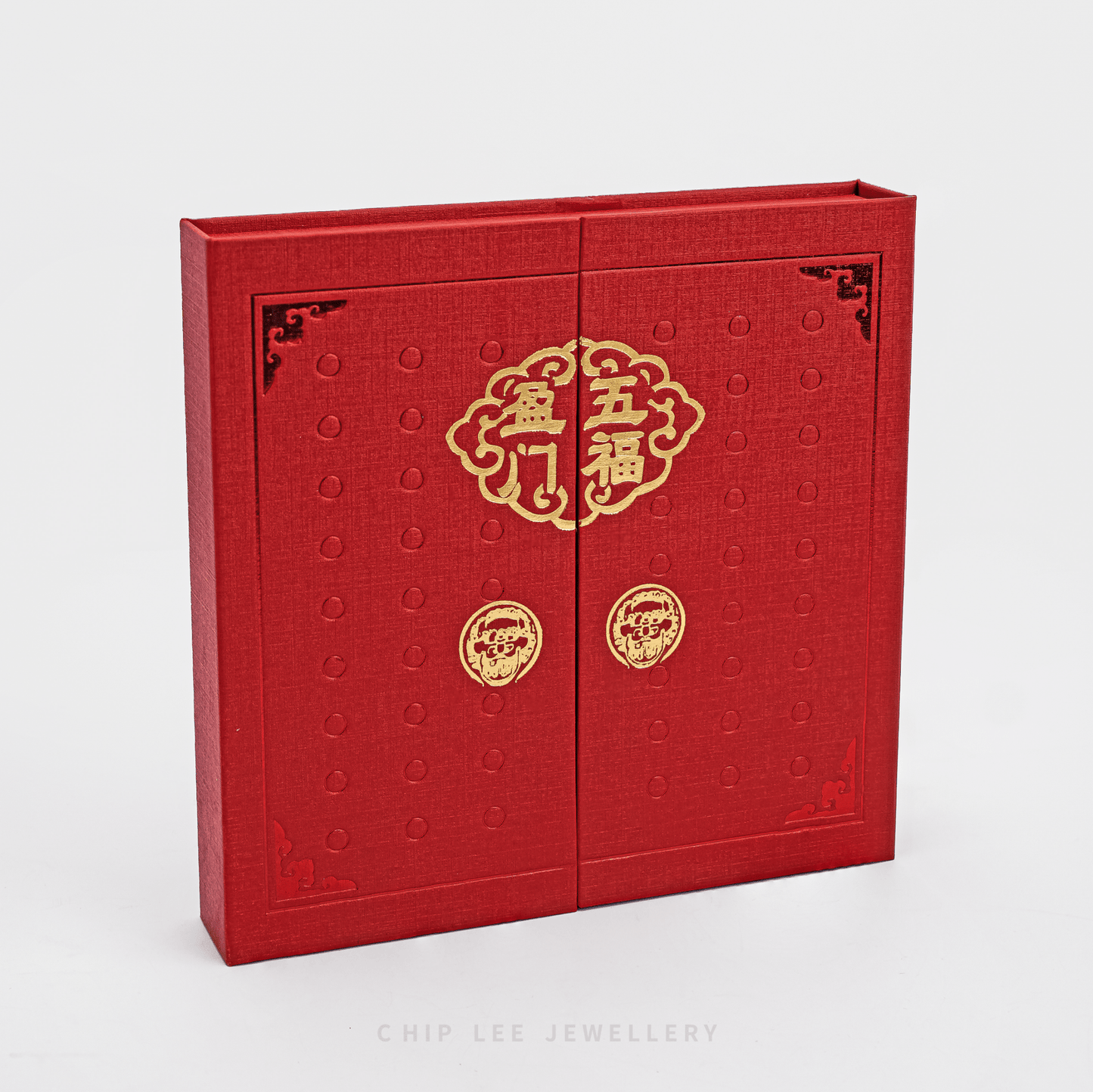 Red jewelry box with gold designs on a white background