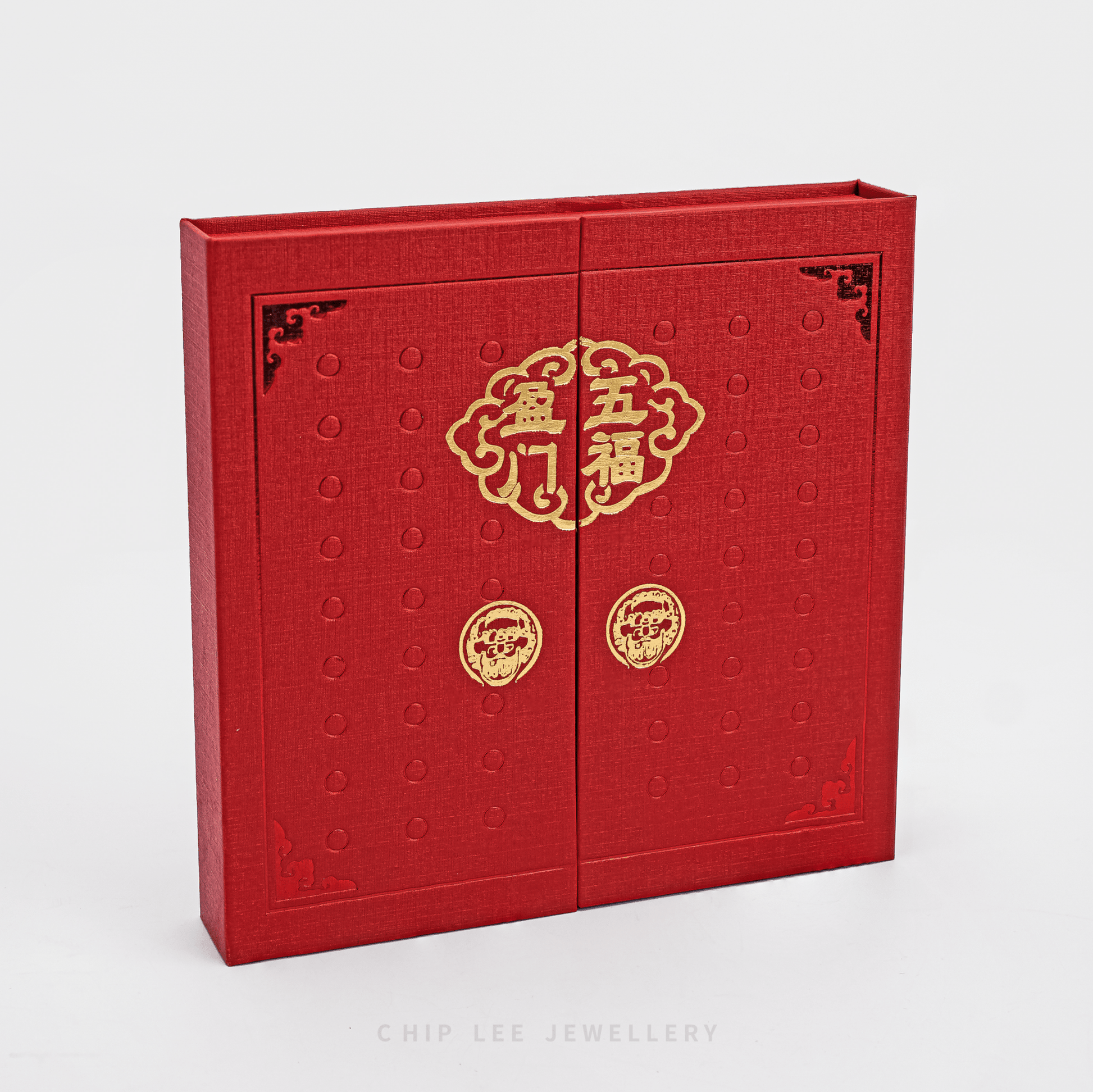 Red jewelry box with gold designs on a white background