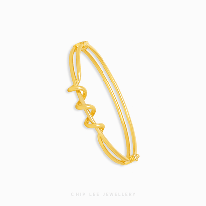 Looped Knot Bangle with bold sculptural knot design, modern statement style, elegant women’s jewelry bracelet