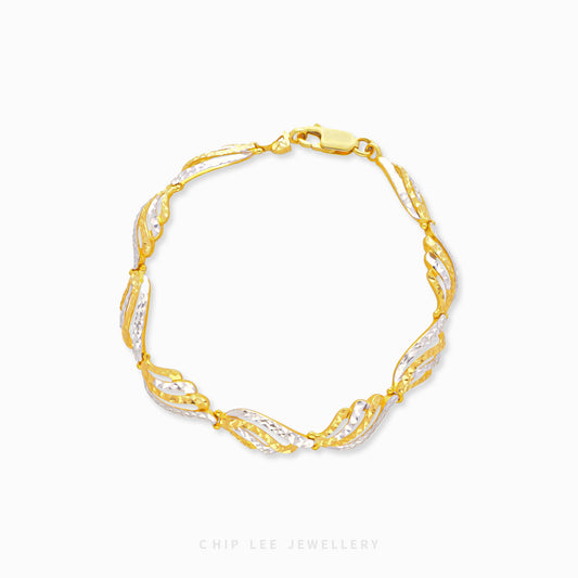 916 gold Seraphina wing design bracelet featuring intertwined yellow and white gold-toned links with flowing feather-like details