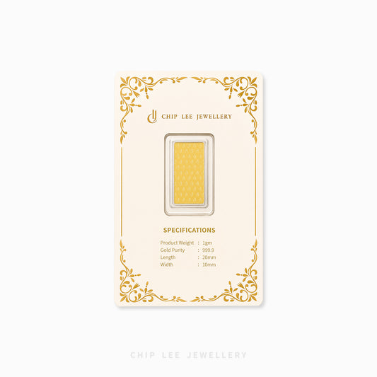 A gold bar specimen in a clear display window on a cream-colored backing card with gold ornamental borders and 'CHIP LEE JEWELLERY' branding, shown against a light gray background.