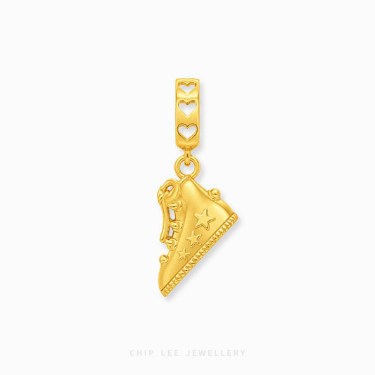 A gold charm pendant shaped like a sneaker with star details, hanging from a heart-patterned top bar, shown on a light gray background with Chip Lee Jewellery branding at the bottom.