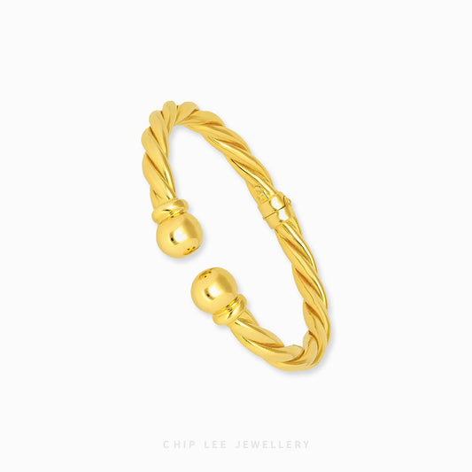 Spiral Cuff Bangle by Chip Lee Jewellery Singapore, 916 gold modern spiral silhouette, fluid lines and elegant standout wrist accessory