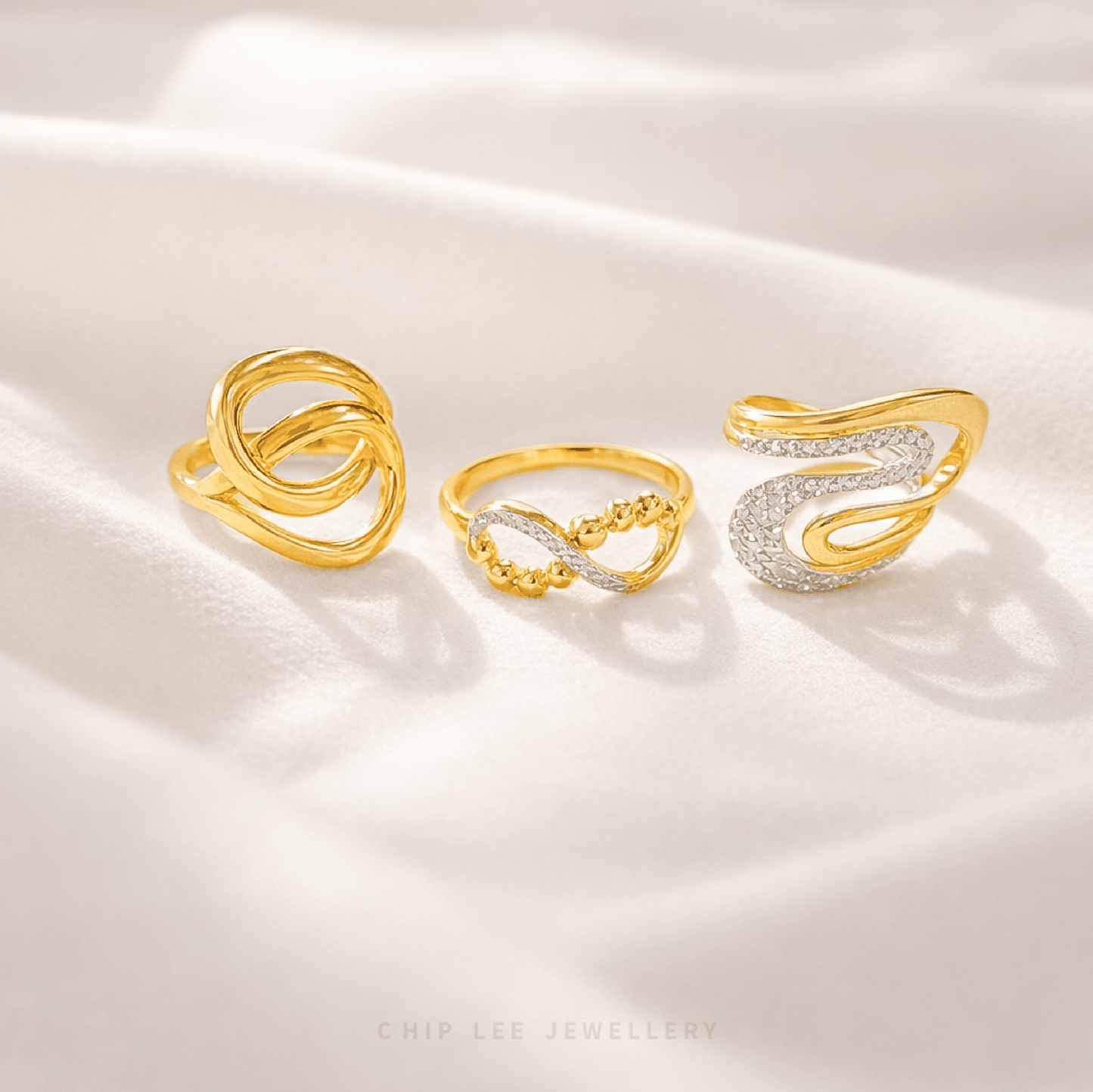 Three gold and silver rings on a white satin background, with 'Chip Lee Jewellery' branding.