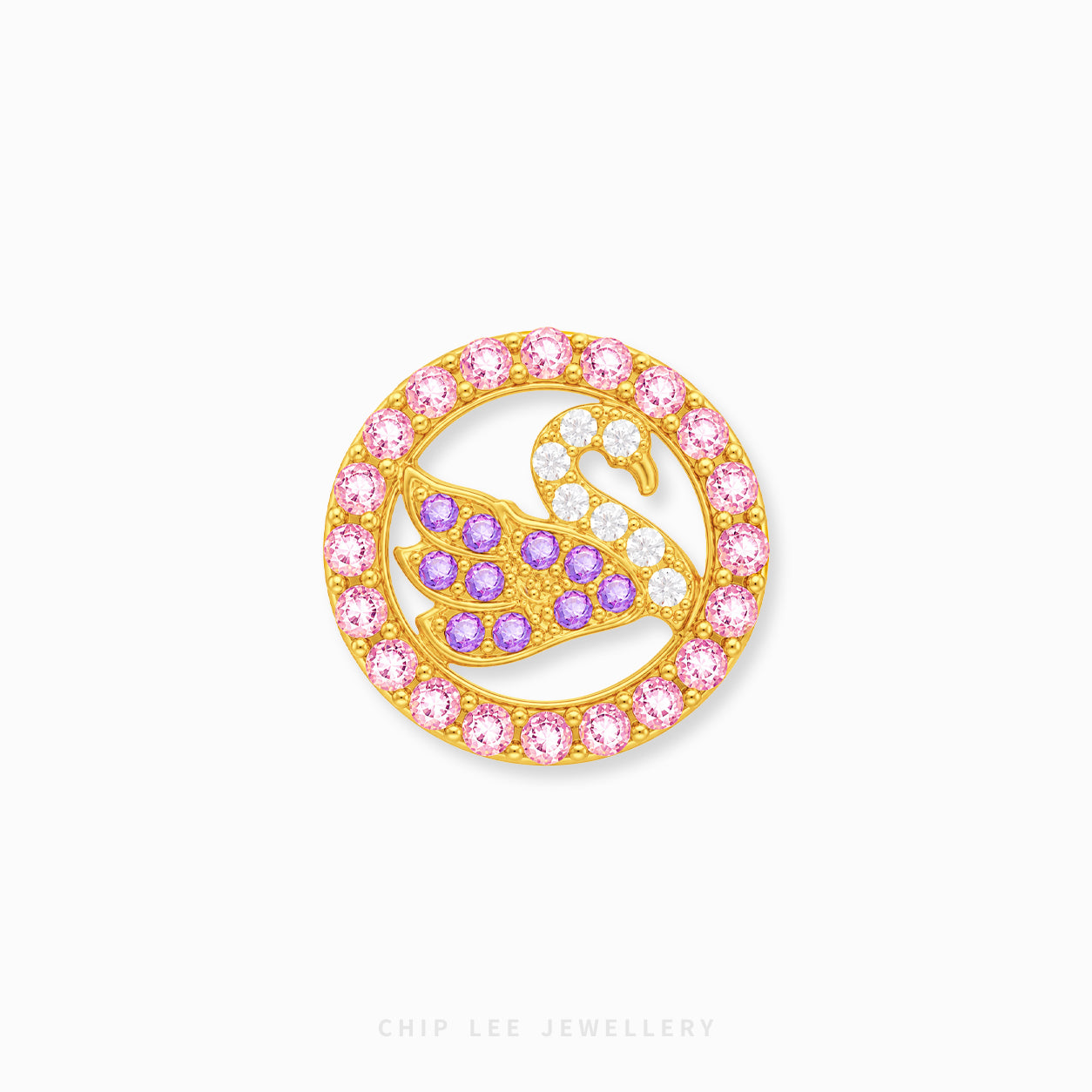 A gold circular brooch featuring a swan motif adorned with pink, purple, and clear crystals, set against a plain white background with a faint brand watermark at the bottom.