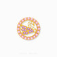 A gold circular brooch featuring a swan motif adorned with pink, purple, and clear crystals, set against a plain white background with a faint brand watermark at the bottom.