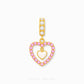 Gold heart-shaped dangle charm with a pink rhinestone border and a central gold heart, shown on a light gray background. The bail features three clear stones.