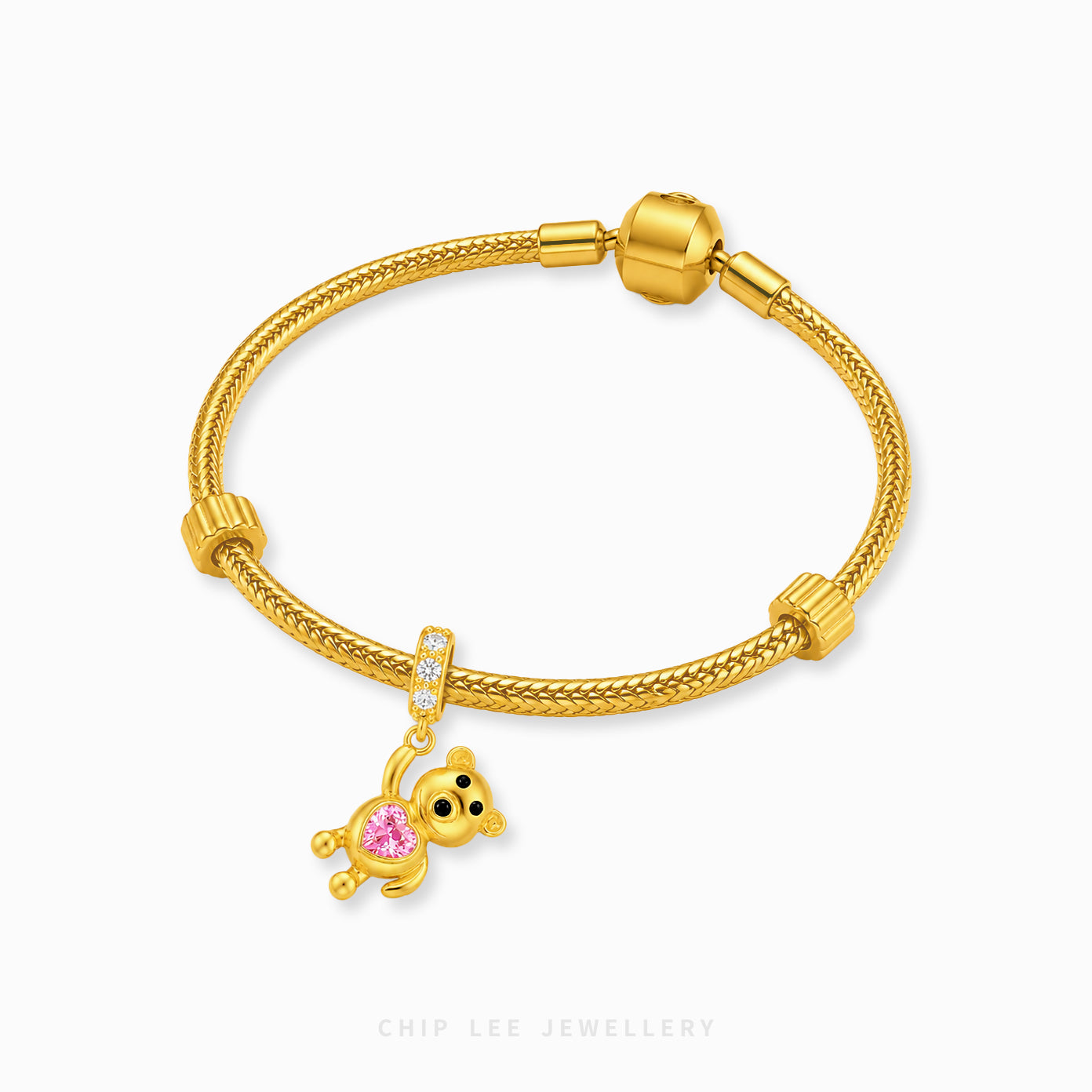 A gold-plated snake-braided bracelet with a small bear charm featuring a pink heart-shaped gemstone, displayed on a clean white background with the brand name 'CHIP LEE JEWELLERY' printed at the bottom.