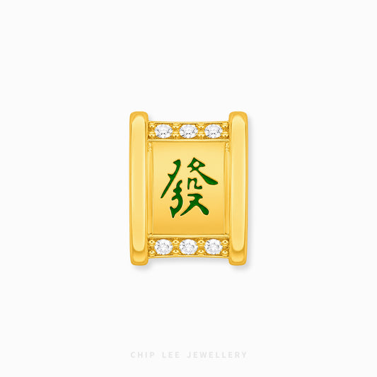A gold rectangular charm with a green Chinese character for 'fortune' in the center, bordered by small clear stones at the top and bottom, shown on a light gray background with Chip Lee Jewellery branding at the bottom.