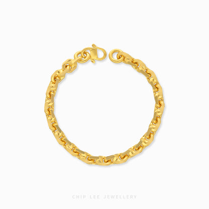 Textured gold chain bracelet with organic interlocking links and clasp closure.