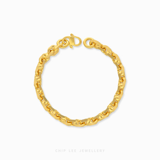 Textured gold chain bracelet with organic interlocking links and clasp closure.