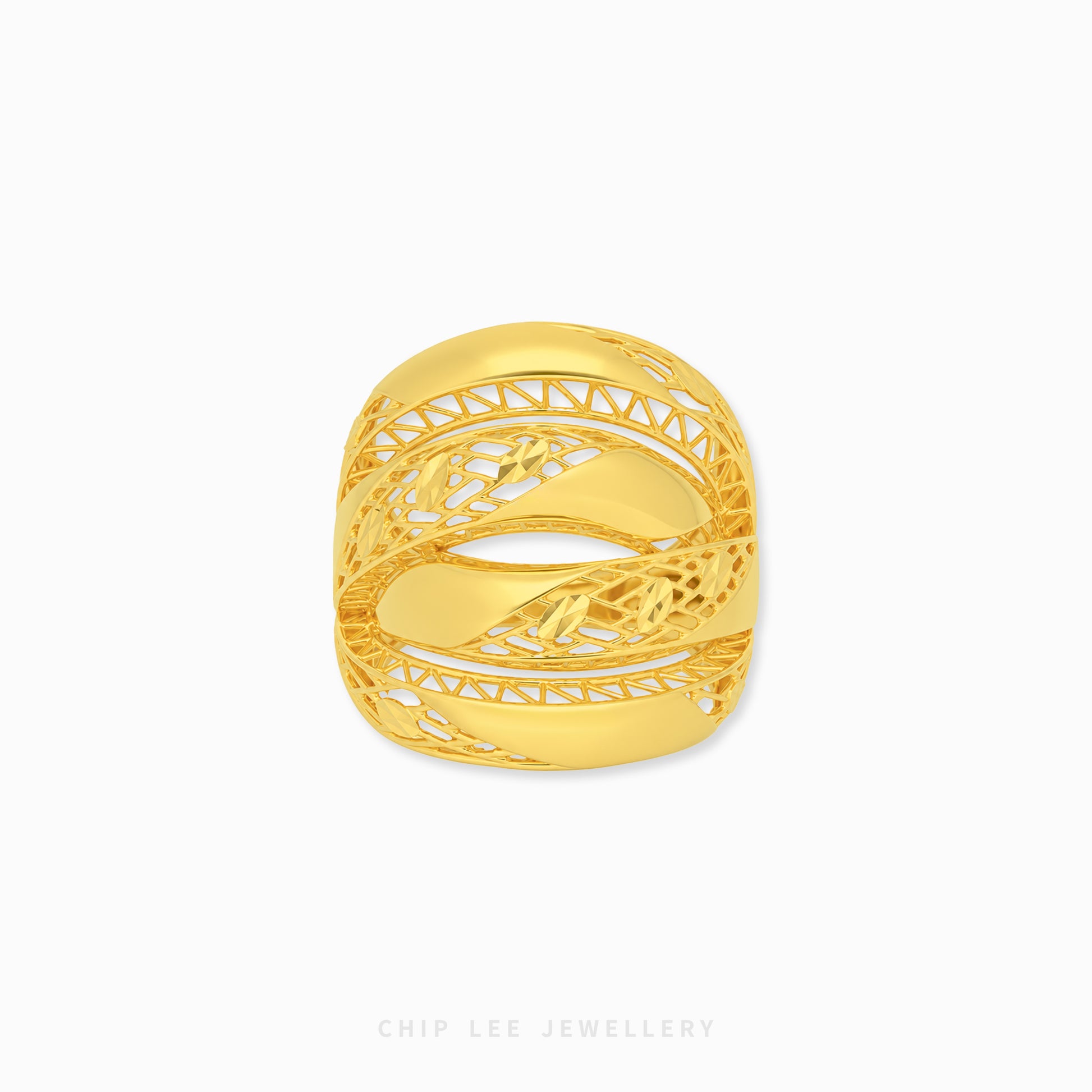 A gold ring with an intricate, openwork filigree design and a central floral motif, shown on a clean white background with a brand watermark at the bottom.