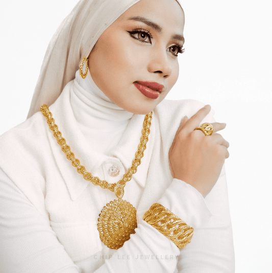 Woman wearing gold jewelry with a white background