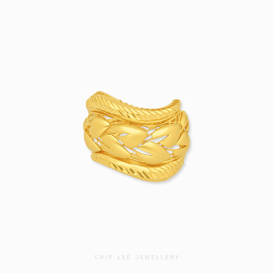 A gold-toned multi-band ring with a textured, braided cable design, shown on a plain white background with a brand watermark at the bottom.